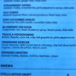 Photo of a drink menu with "Tequila Mockingbird" in focus; made from Bribon Tequila, Licor 43, ruby red grapefruit and pink peppercorns